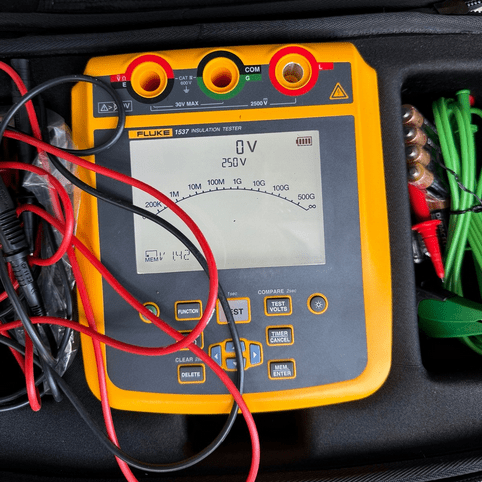 FLUKE 1537 insulation tester packed inside official carrying pouch bag with 250V test range selected, ready for measurement