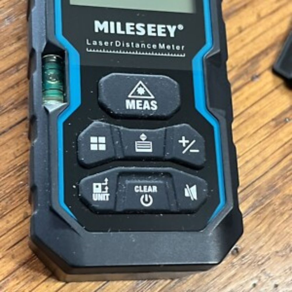Mileseey S6 electronic distance meter – closeup of keypad buttons showing measurement mode controls and mute function