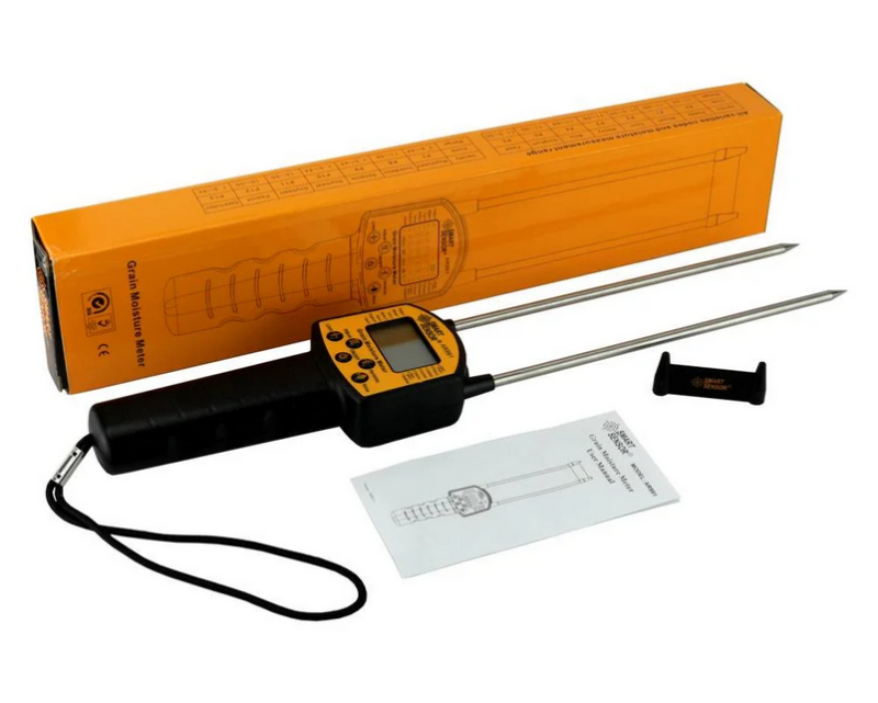 Digital grain moisture meter with two probes and packaging on a white background