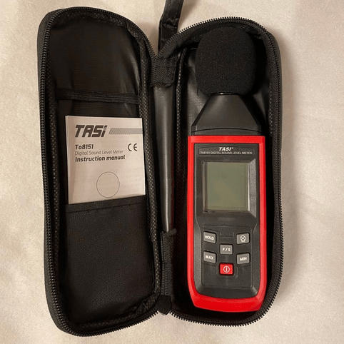 The TASI TA8151 sound level meter and its manual stored safely inside the included soft carrying pouch for easy transport and protection.