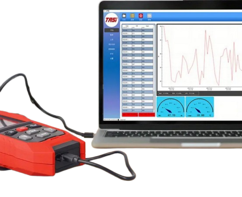sound level meter data logger connected to a laptop displaying software with graphs and data.