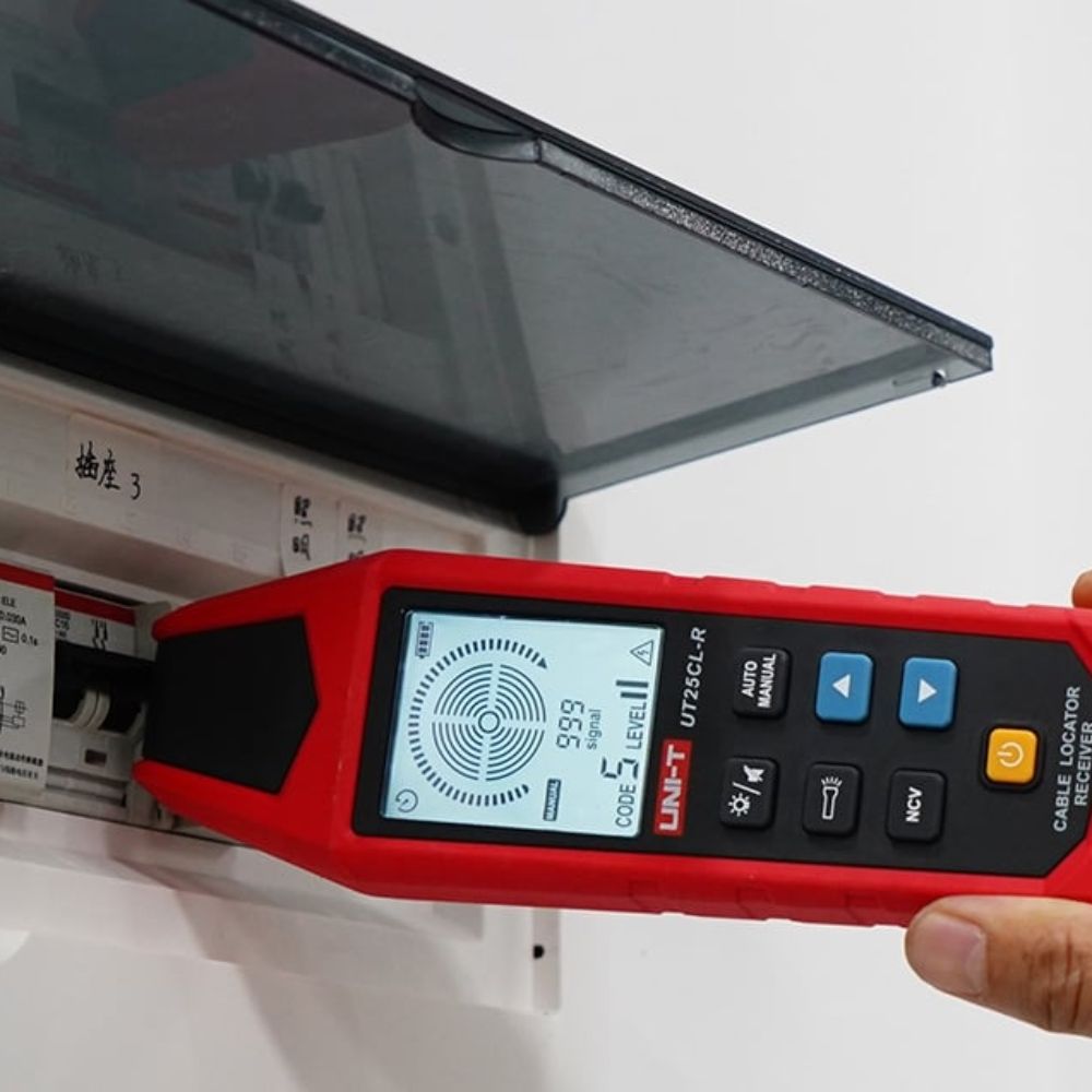 UNI-T UT25CL cable locator tracing wires on an electrical breaker board