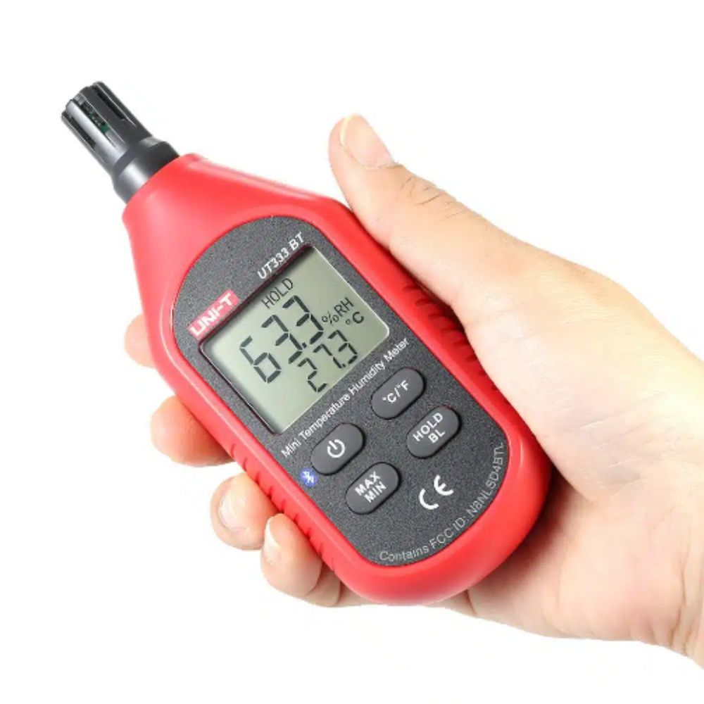 Handheld UNI-T UT333BT lightweight digital air temperature and humidity meter, featuring an ergonomic design for easy one-handed operation during field inspections.