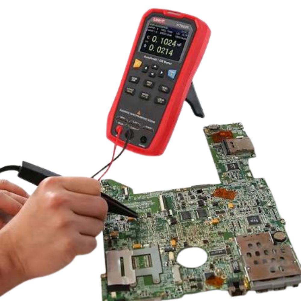 UNI-T UT622A handheld LCR meter testing components on a complex circuit board