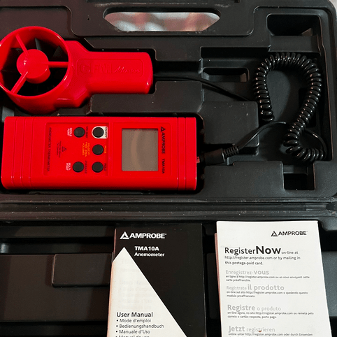 The AMPROBE TMA10A anemometer and vane probe stored neatly inside its open hard carrying case, showcasing the instrument's professional organization and portability.