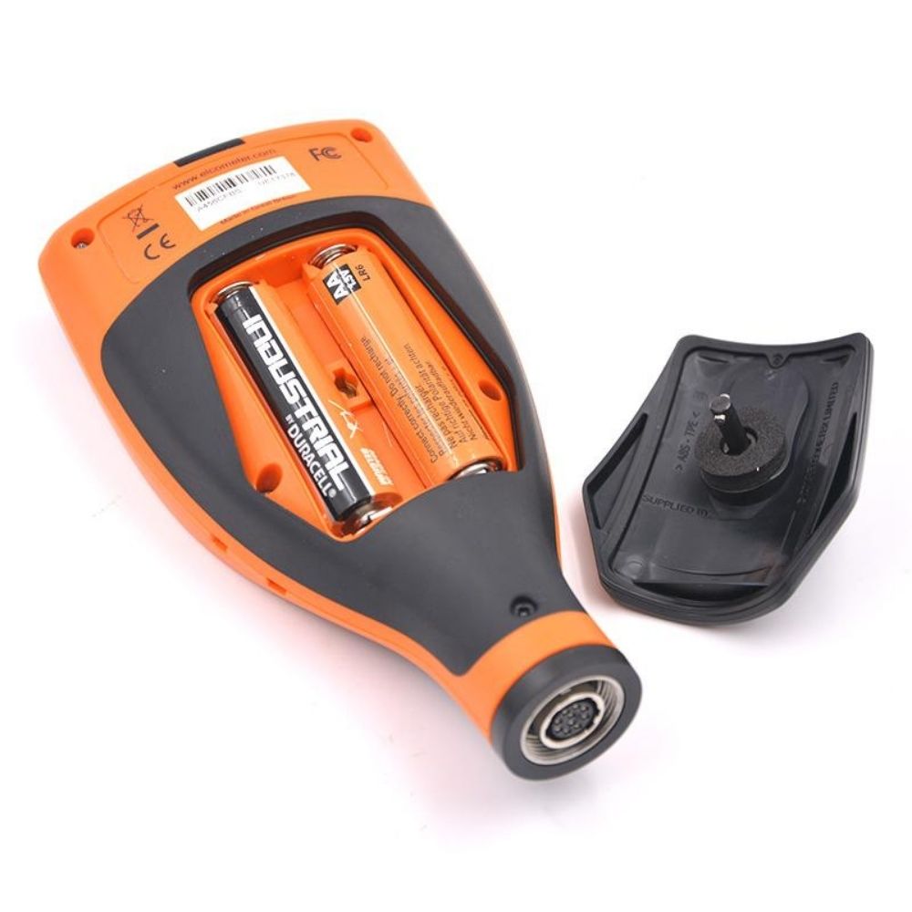 Elcometer 456 Separate Coating Thickness Gauge rear view with battery cover removed, showing two orange AA batteries inside rugged IP64 industrial coating thickness meter.