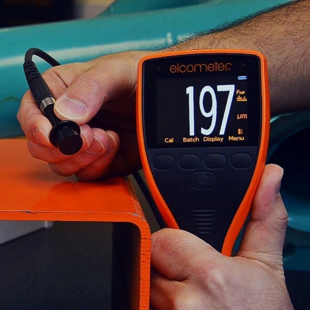 Elcometer 456 Separate Coating Thickness Gauge measuring coating thickness on heavy metal railing, professional DFT gauge reading 197 µm for anti-corrosion paint inspection.