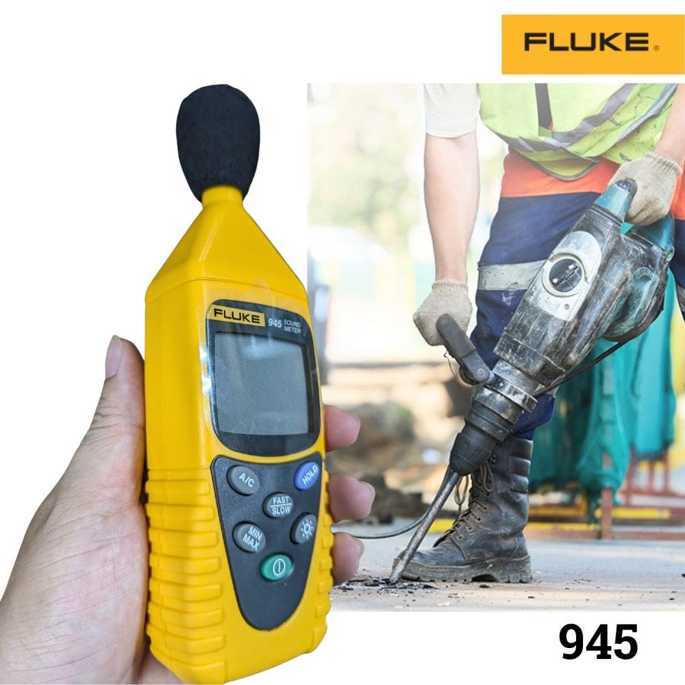 A safety officer using the Fluke 945 noise meter to measure sound levels on a construction site, with a worker operating a Hilti hammer in the background.