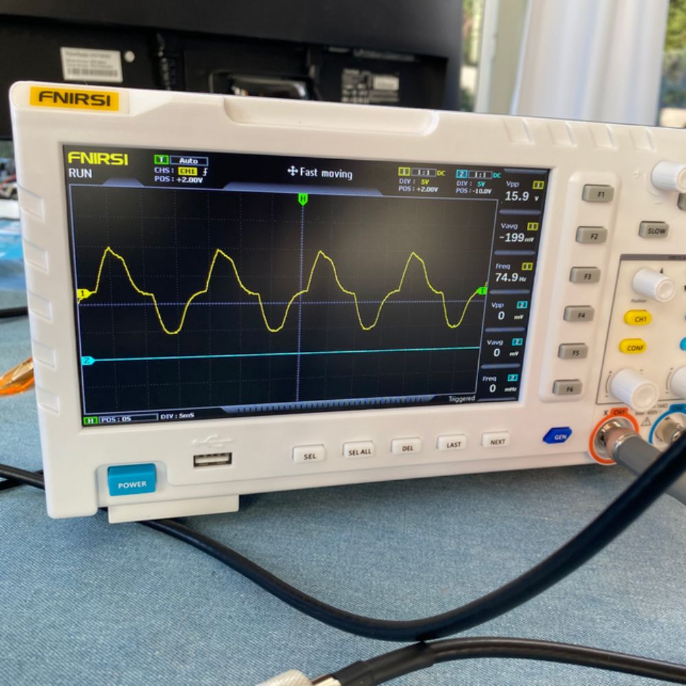 FNIRSI 1014D 100MHz 2-Channel Digital Oscilloscope performing test analysis showing dual-channel waveform capture with measurements and cursors on 7-inch color display - Electronics troubleshooting Sri Lanka.