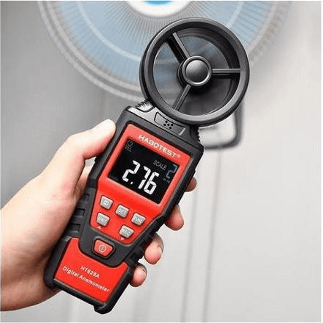 An HVAC professional uses the HABOTEST HT625A handheld anemometer to test and balance the air flow velocity directly from an overhead ceiling fan.
