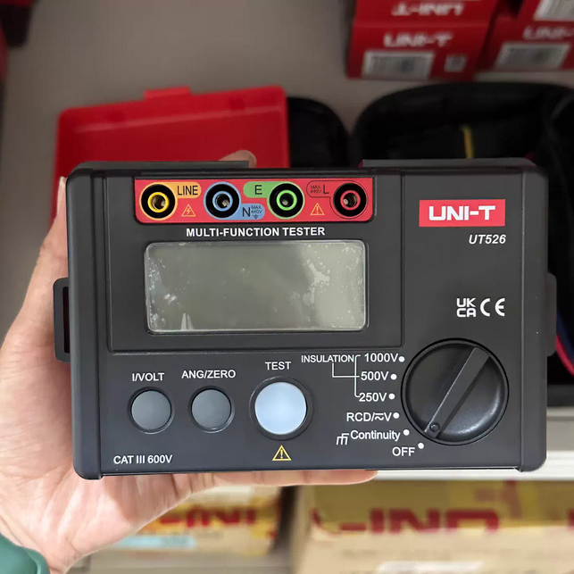 A technician holding the UNI-T UT526 electrical insulation tester, showcasing its compact, handheld design ideal for field work in Sri Lanka.