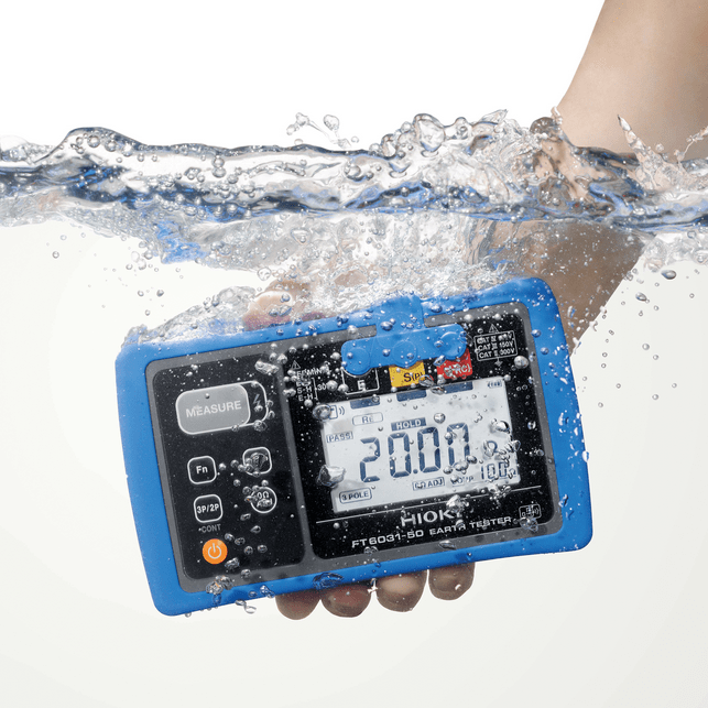 Demonstrating the IP67 waterproof rating of the HIOKI FT6031-50 earth tester, submerged in water while displaying a live measurement.