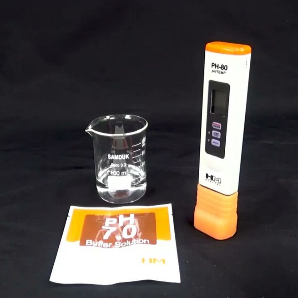 HM Digital PH-80 pH HydroTester being calibrated using pH 7.0 buffer solution with one-touch calibration function