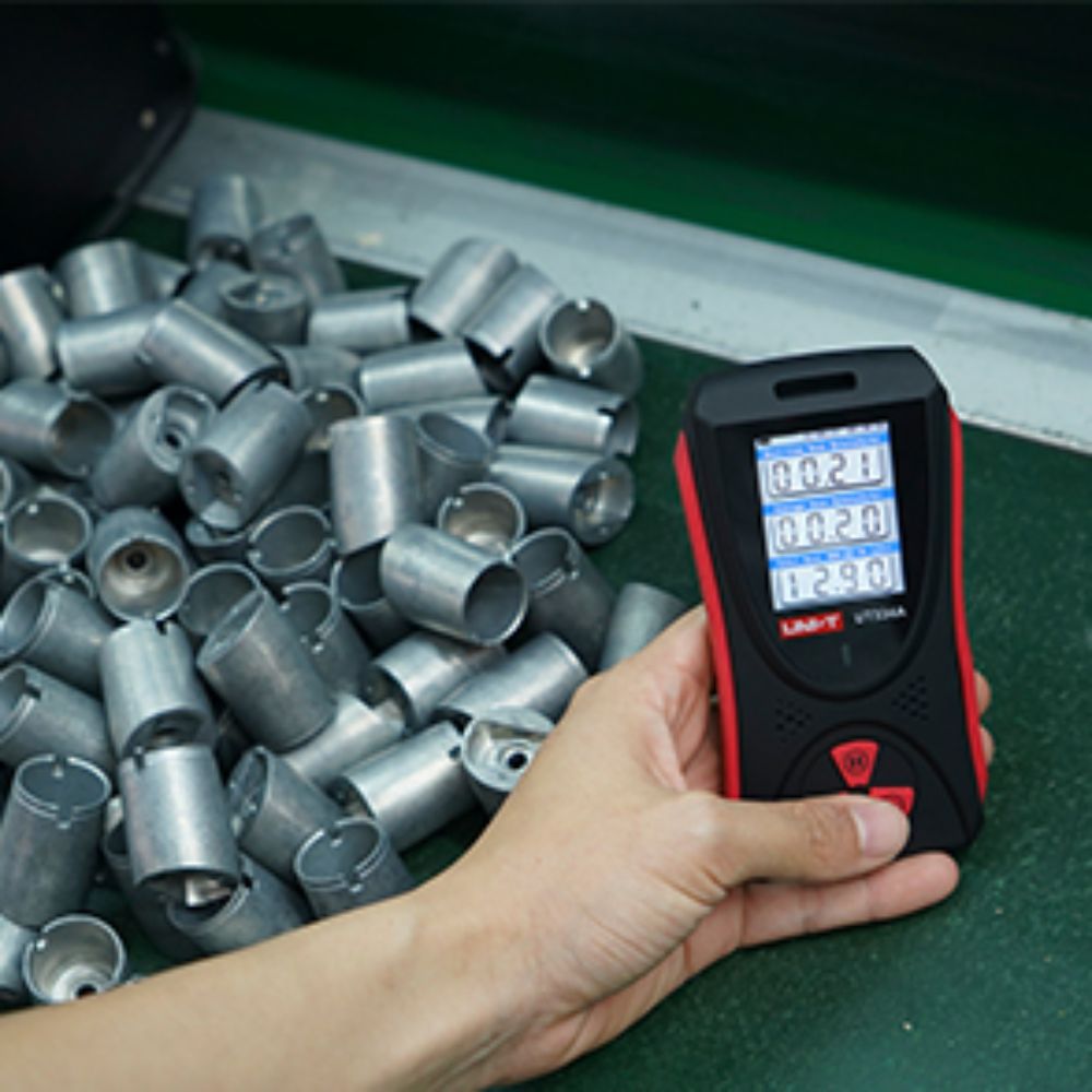 Industrial safety technician using the UT334A Geiger Counter to scan metal containers for X-ray and Gamma radiation leaks at a Sri Lankan port.