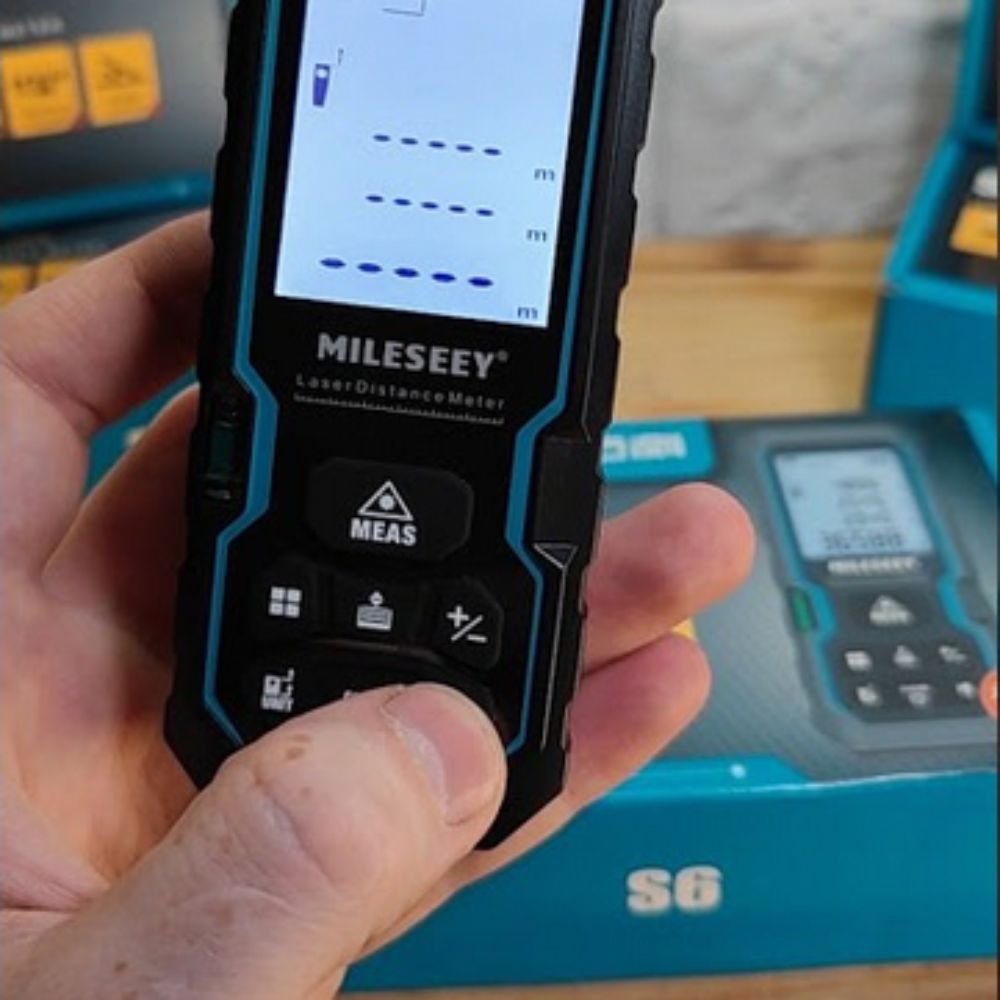 Mileseey S6 handheld laser rangefinder held and ready to take a distance measurement on site