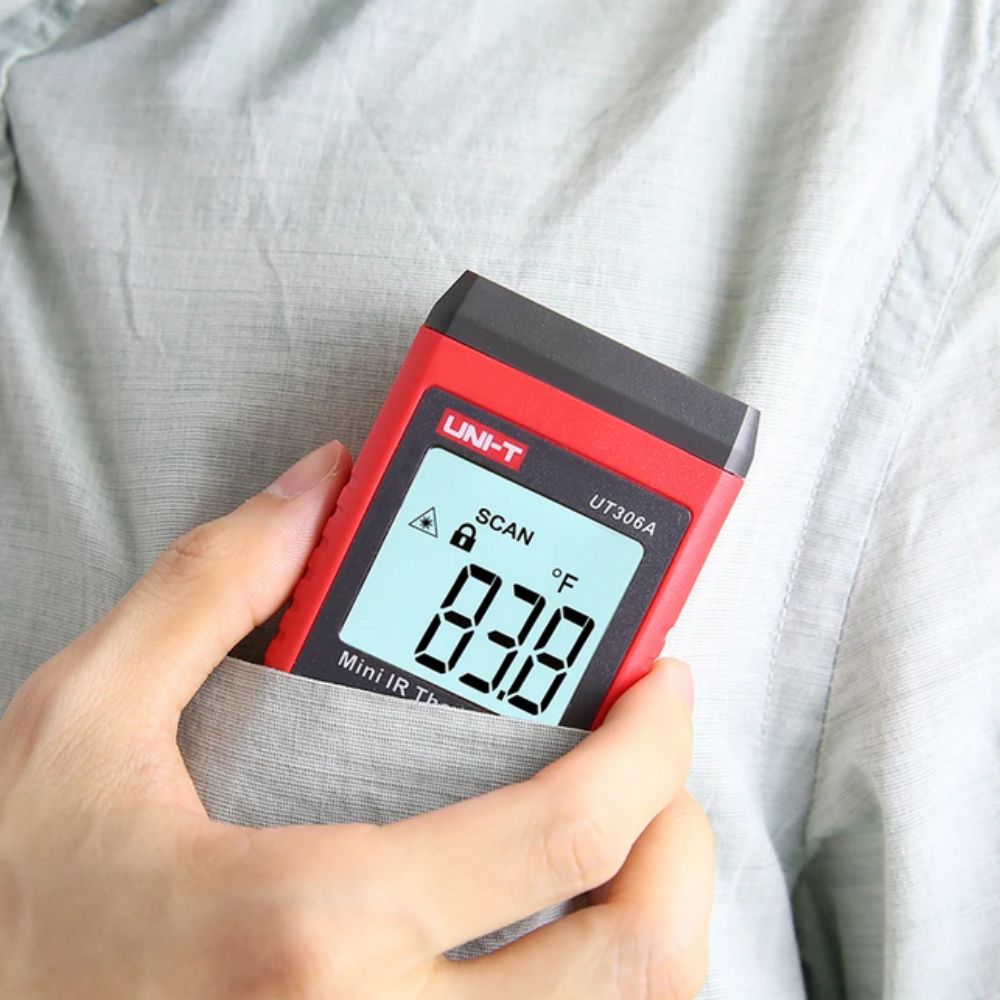 HVAC technician carrying the compact UNI-T UT306A mini IR laser thermometer in a shirt pocket, demonstrating its portable lightweight design for field work