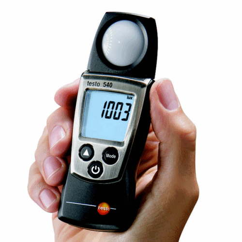 The compact TESTO 540 digital light meter held in the palm of a hand, showcasing its portability and a clear 1003 Lux measurement.