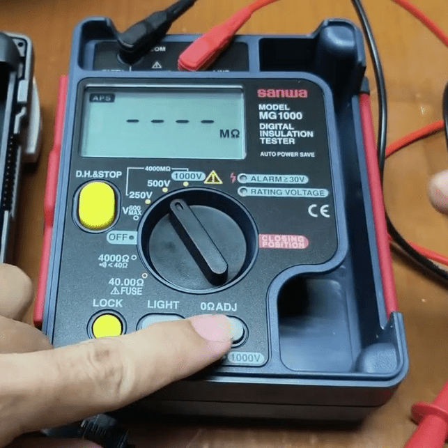 SANWA MG1000 insulation tester powered on with 500V test voltage and test leads connected ready for measurement