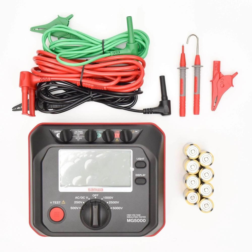 Sanwa MG5000 insulation tester powered off, with test leads, clips, and batteries laid out for inspection.