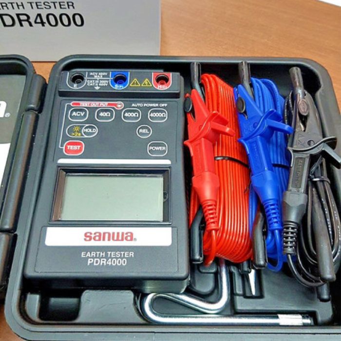 A close-up view of the SANWA PDR4000 kit inside its case, with a clear focus on the meter, auxiliary earth spikes, and neatly packed test leads.