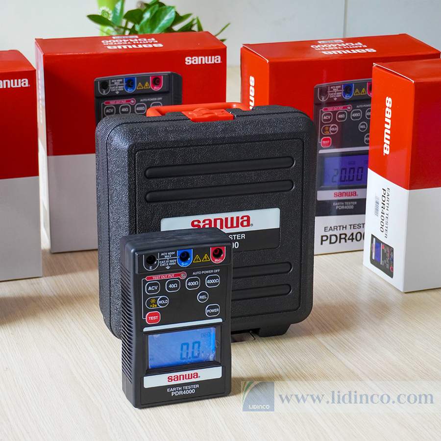 The SANWA PDR4000 ground resistance meter is shown powered on, with its official carrying case and retail packaging displayed in the background.