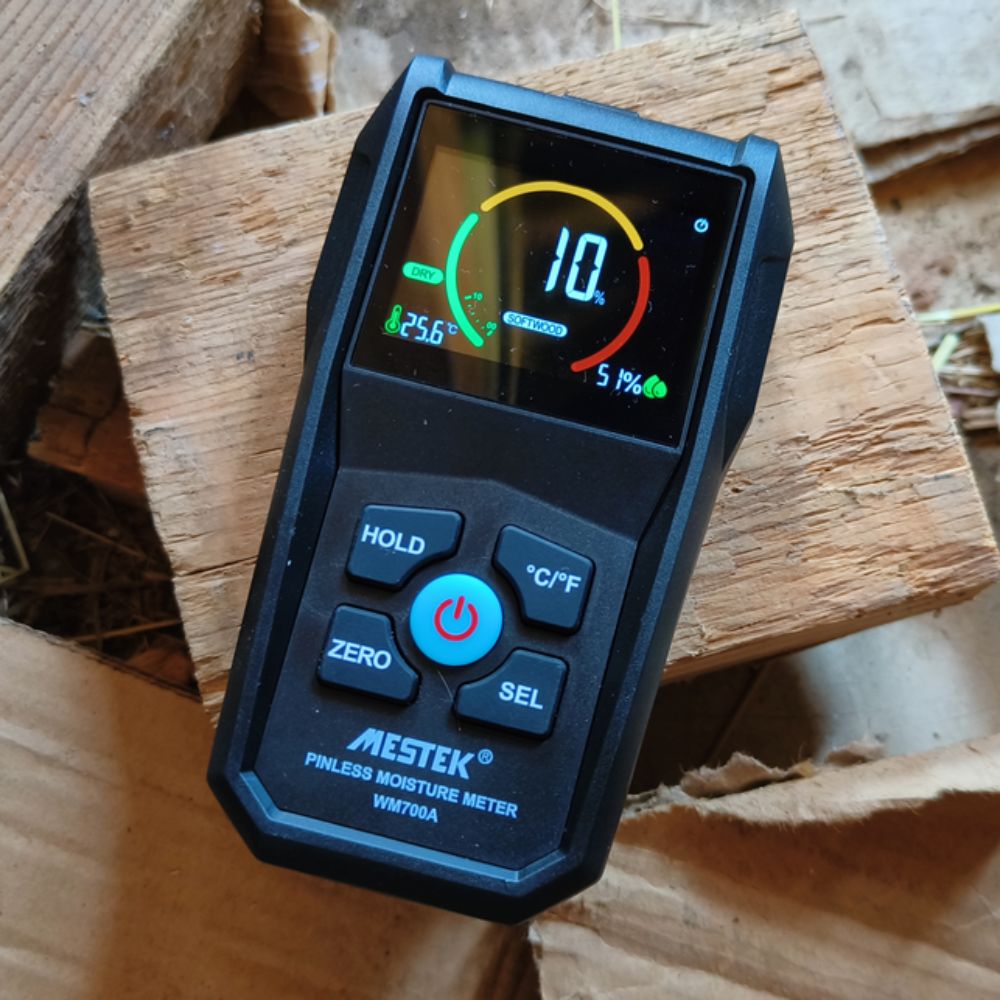 Checking soft wood moisture content with Mestek WM700A inductive timber tester showing 10% dry wood reading.