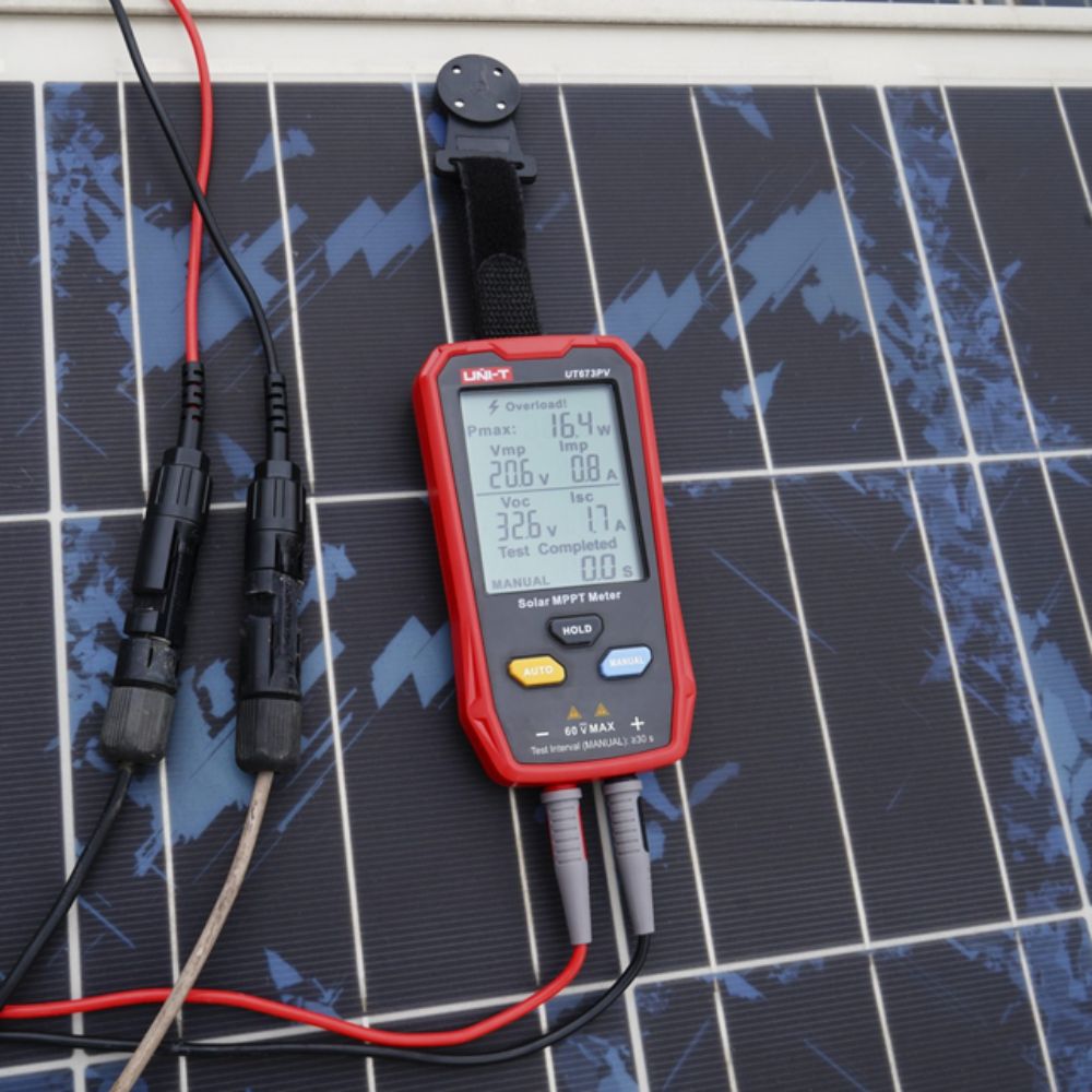Portable Photovoltaic Analyzer UNI-T UT673PV performing an MPPT scan on a solar panel with manual mode results showing Vmp 20.6V and Isc 1.7A.