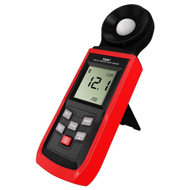 The TASI TA8121 lux meter resting on its integrated back stand for hands-free use, displaying a reading of 12.1 Lux.