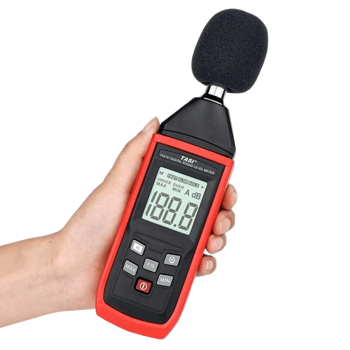 A technician holding the TASI TA8151 sound meter during its power-on self-test sequence, preparing to take an accurate noise level measurement.