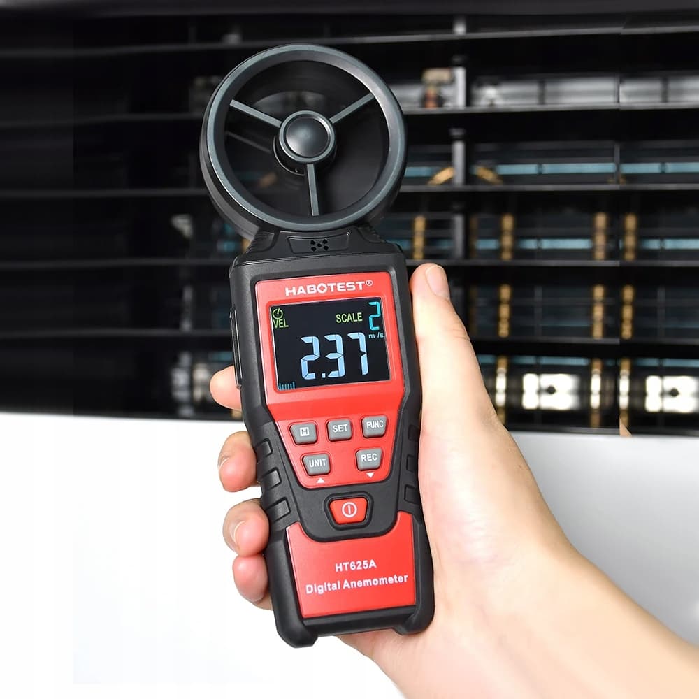 A technician using the HABOTEST HT625A to measure air velocity from an industrial condenser unit, ensuring optimal performance for the HVAC system.