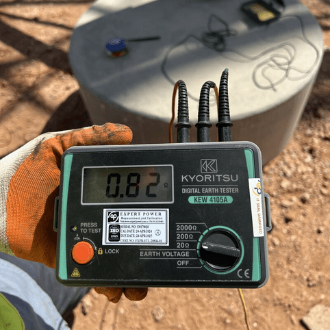 A technician conducts an on-site earth pit resistance test in Sri Lanka with the KYORITSU KEW 4105A, which displays a low resistance reading of 0.82 ohms.