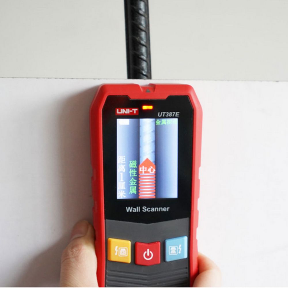 Professional technician using the UNI-T UT387E wall scanner to detect hidden metal pipes and live electrical wires before drilling.