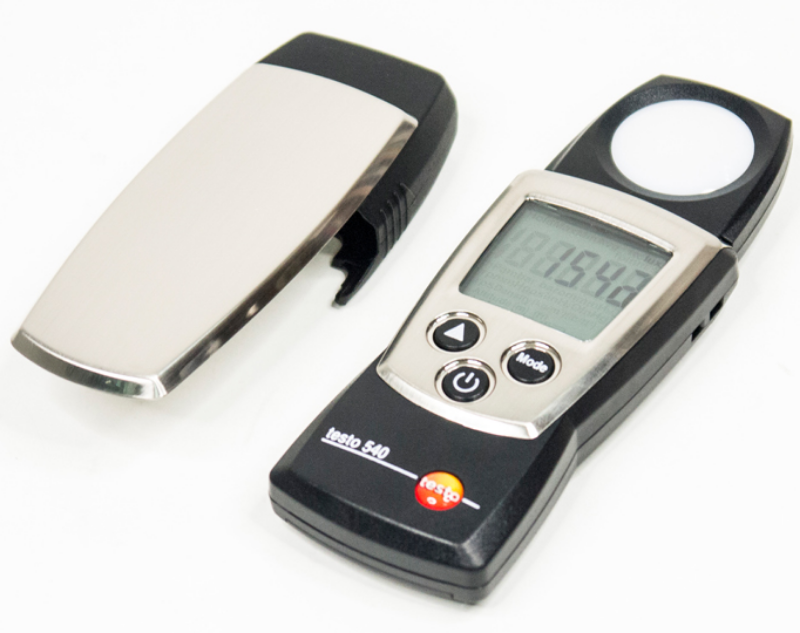 TESTO 540 light meter with the battery cover removed, displaying a 1542 Lux reading on the front screen.