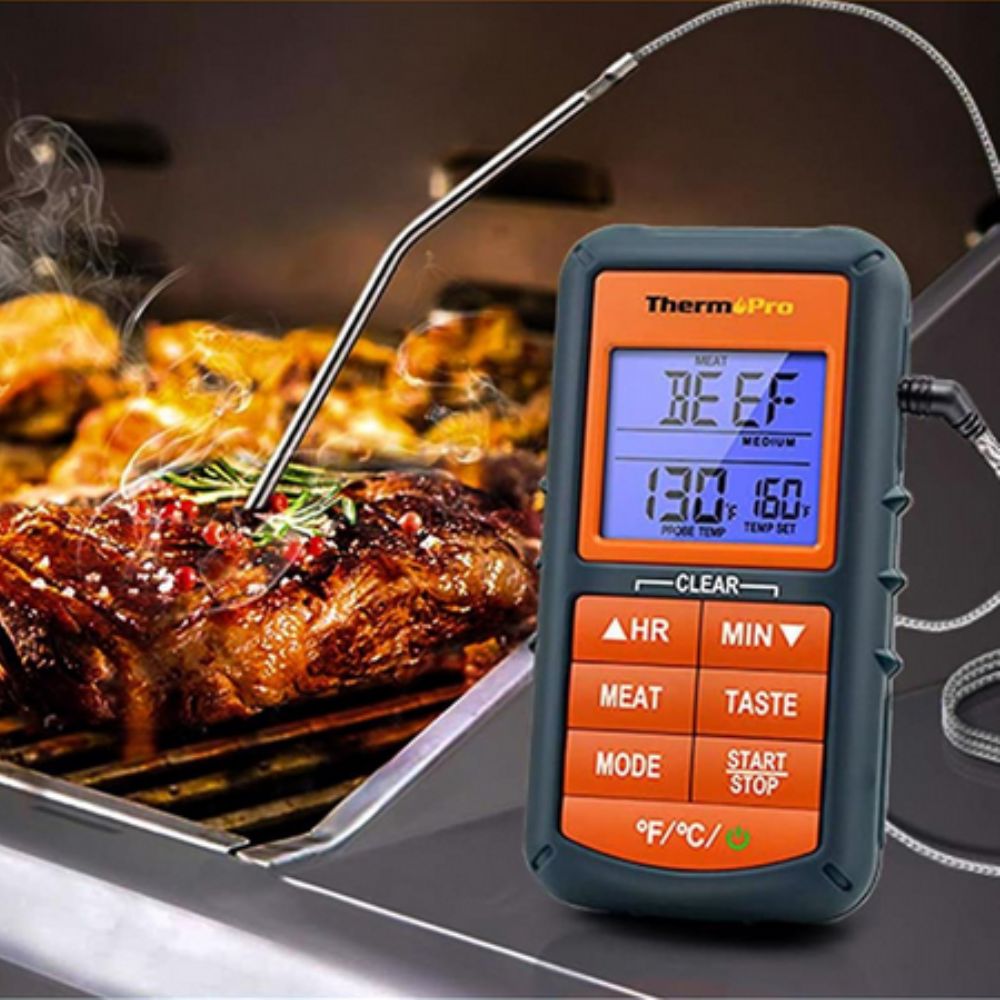 Professional ThermoPro TP06B BBQ thermometer probe inserted into a beef steak inside an oven, monitoring real-time internal temperature at 130°F toward a 160°F target.