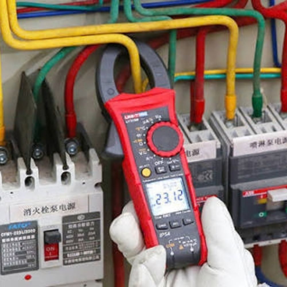 UNI-T UT219DS clamp meter testing current on an industrial power distribution panel