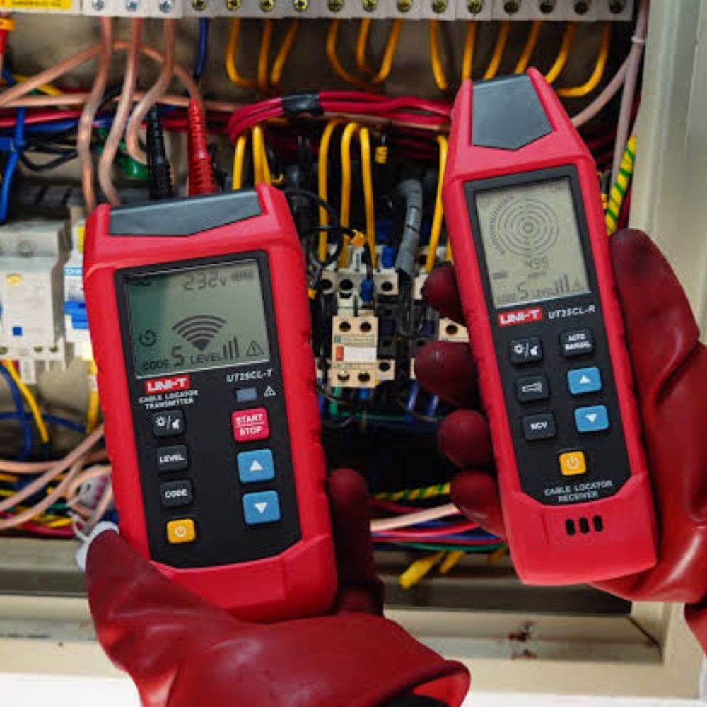 UNI-T UT25CL wire tracer locating cables on an electrical panel board