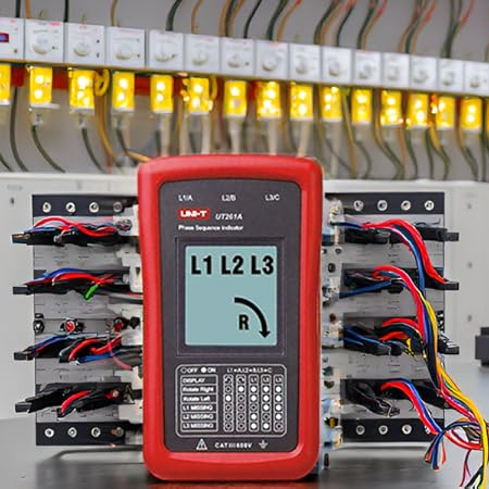 UNI-T UT261A Phase Rotation Tester on, background shows a large electrical distribution panel