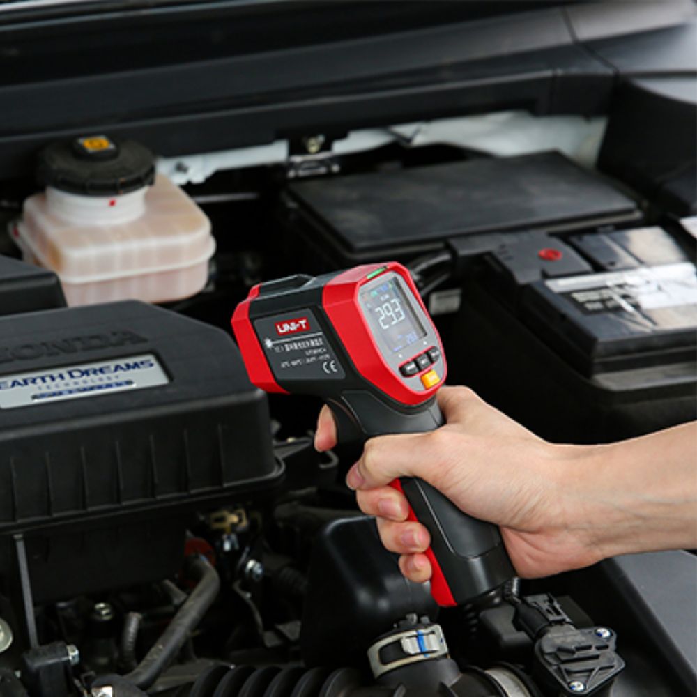 UNI-T UT303D+ infrared thermometer with 30:1 distance-to-spot ratio performing non-contact vehicle engine temperature measurement