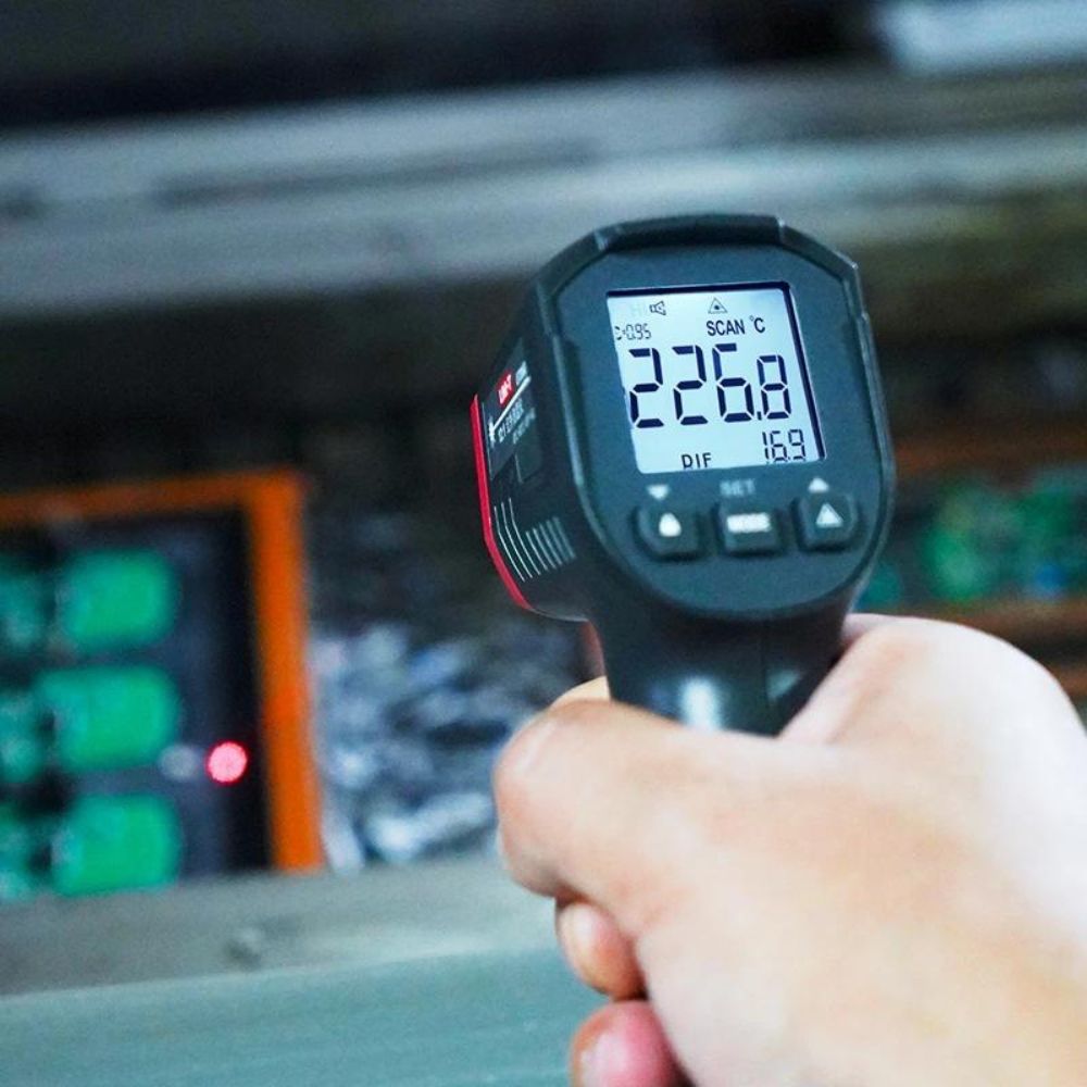 UNI-T UT306S laser infrared thermometer being used to measure electrical circuit board surface temperature