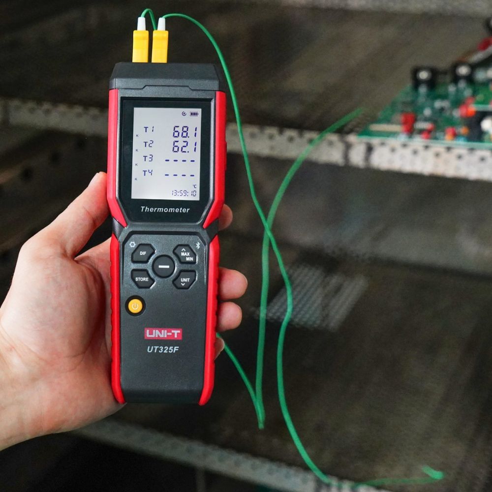 UNI-T UT325F high temperature data logger performing a thermal test with two K-type sensors connected, displaying 68.1°C and 62.1°C.