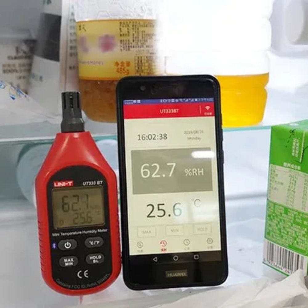 UNI-T UT333BT Bluetooth humidity meter synced with a smartphone via iENV app, demonstrating live remote temperature monitoring and real-time data logging on mobile display.