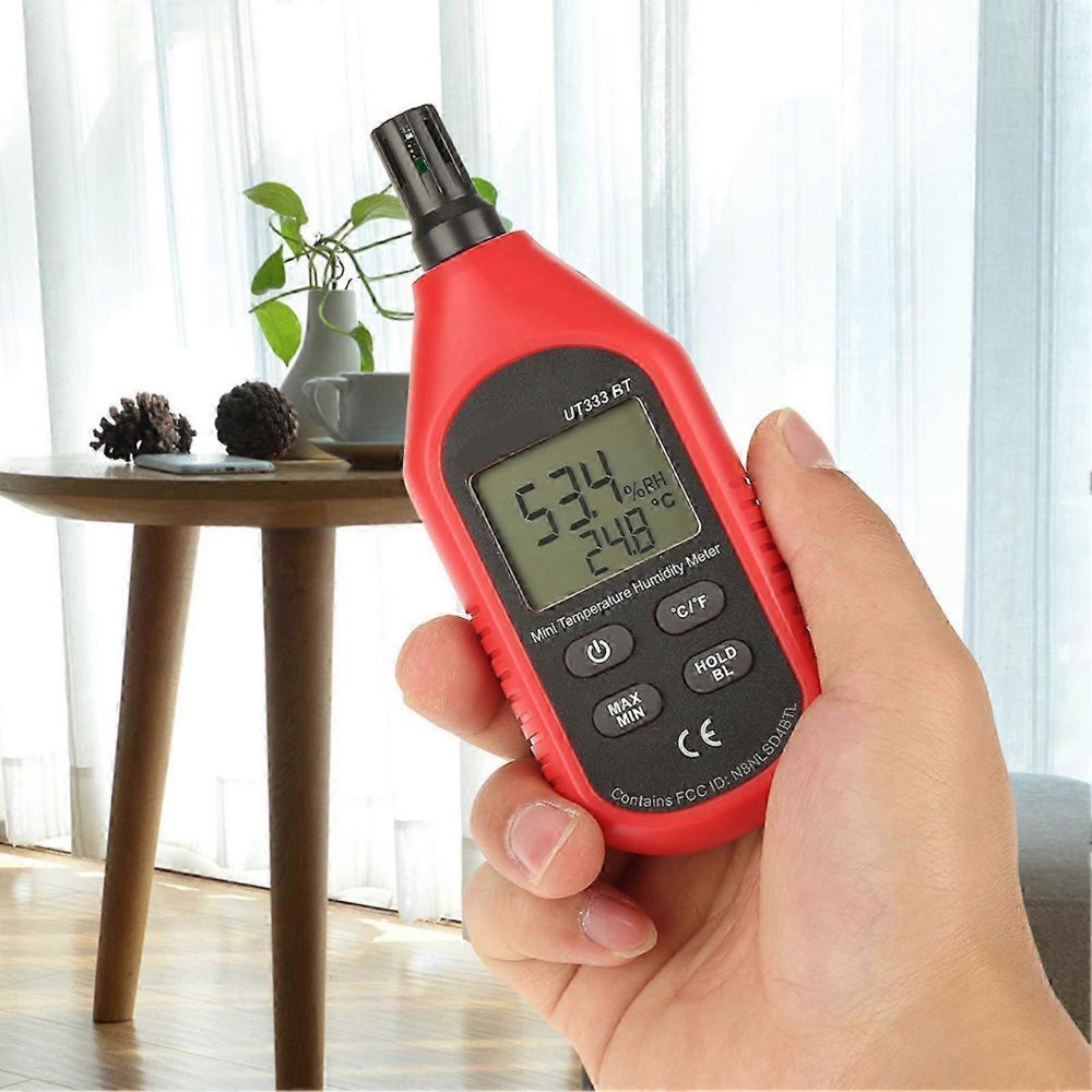 UNI-T UT333BT mini humidity tester used indoors showing 24.8°C and 53.4% RH, ideal for monitoring warehouse climate, greenhouse conditions, and office ventilation in Sri Lanka.