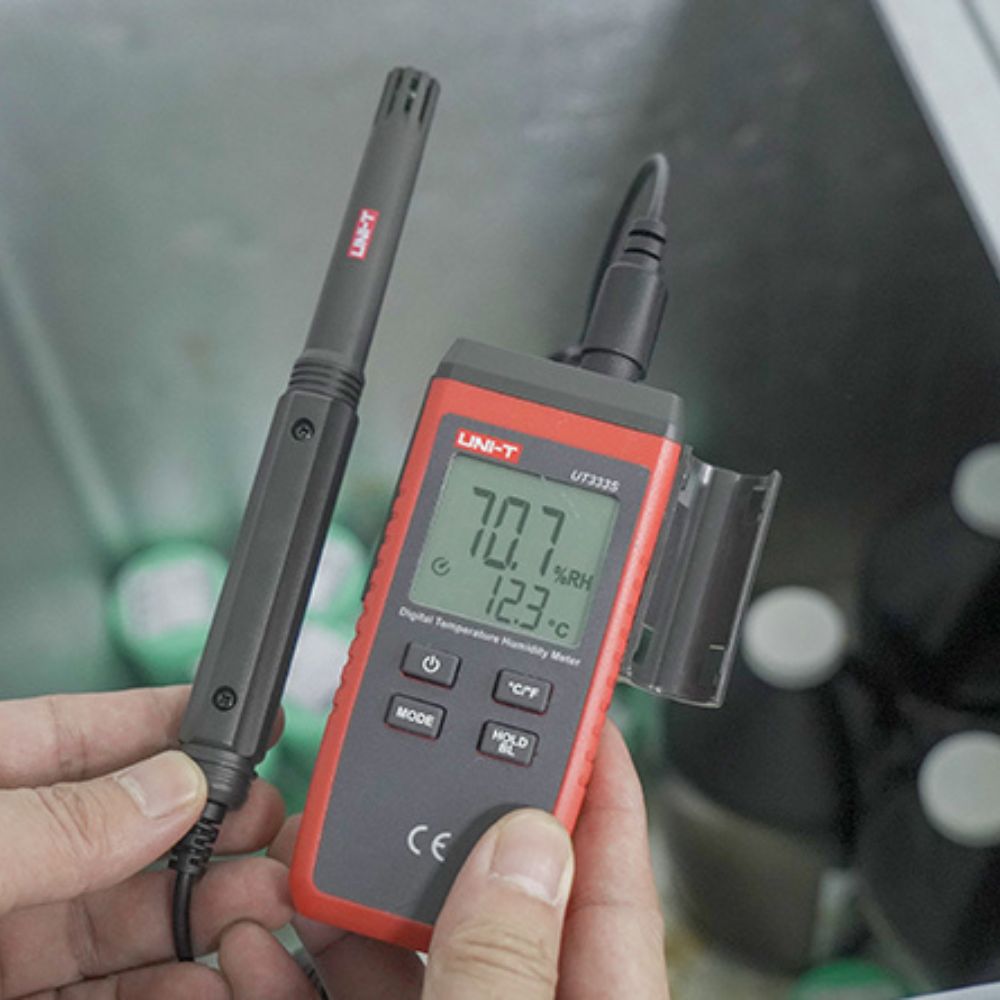 UNI-T UT333S digital thermo hygrometer measuring indoor room environment temperature and humidity with probe in a controlled space