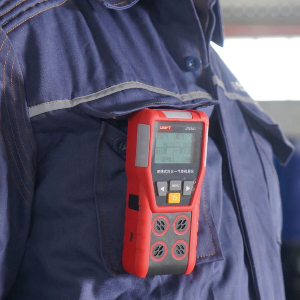 Industrial worker wearing UNI-T UT334E+ Multi Gas Detector on jacket for personal safety monitoring - 4-in-1 gas leak detector O2 CO H2S EX for oil gas manufacturing confined space protection