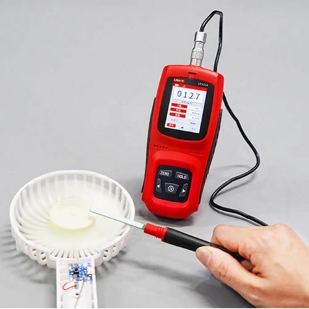 UNI-T UT335C measuring working fan motor center, 12.7mT reading on color display, backlight active for industrial testing