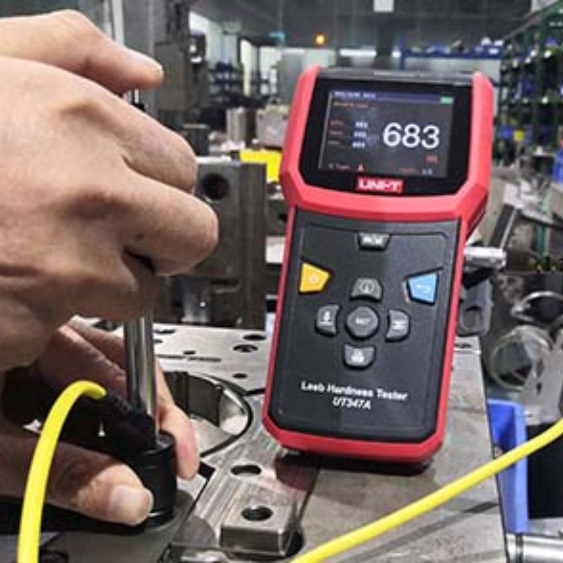 UNI-T UT347A Hardness Tester in use at machinery plant testing turbine shafts, pressure vessels and heavy equipment - 7 impact devices thermal printing industrial QC Sri Lanka.