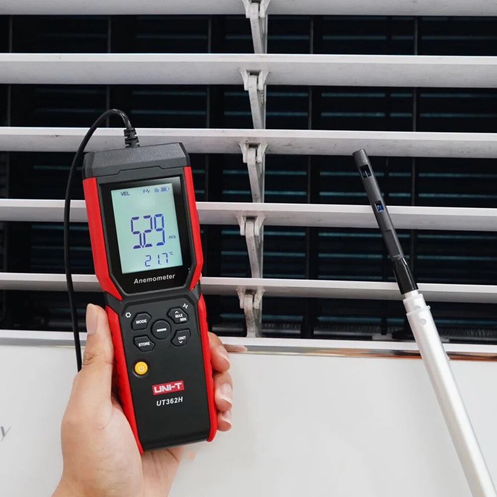 Technician performing an air balancing test on a ventilation window with the UNI-T UT362H hot-wire anemometer, ensuring proper building air flow and circulation.