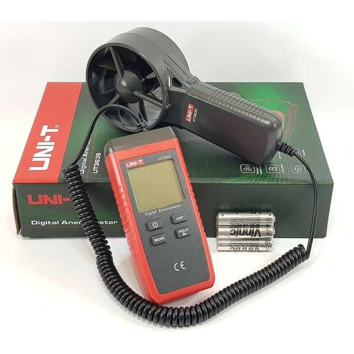 The UNI-T UT363S digital anemometer and its split-vane sensor laid on the retail box, shown with the included AAA batteries, ready for use.