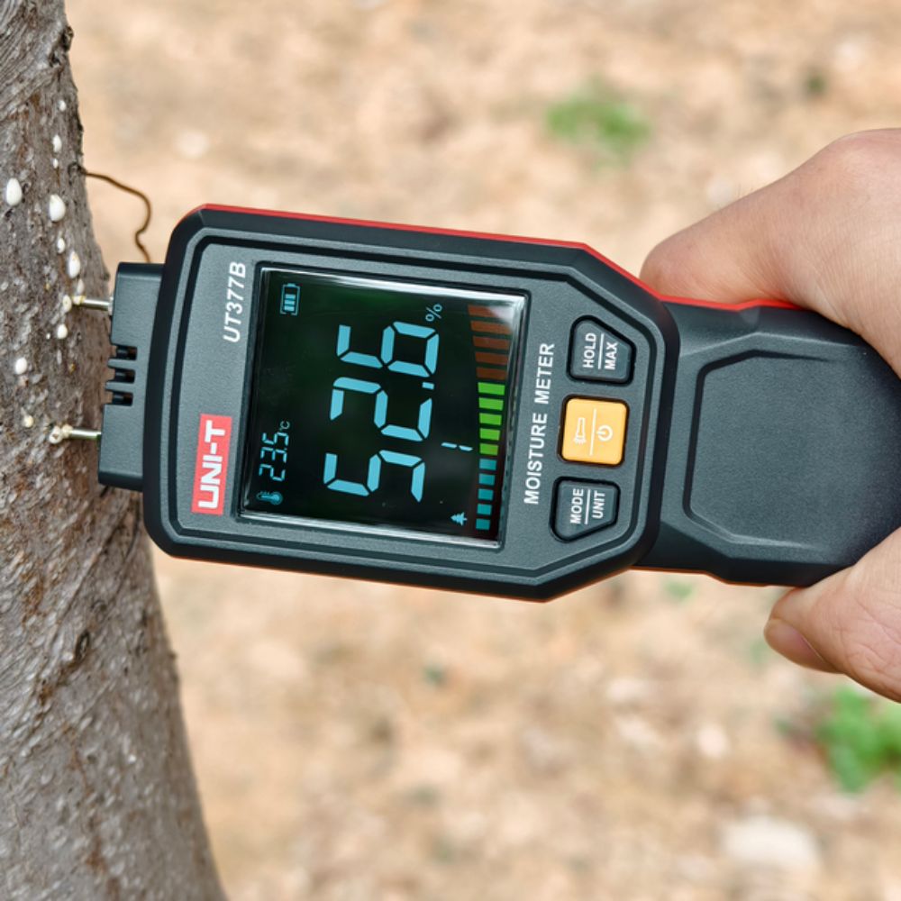 UNI-T UT377B timber moisture meter testing live tree wood moisture level 52.6%, forestry logging carpenter tool, pin-type hygrometer for high moisture lumber detection and quality assessment