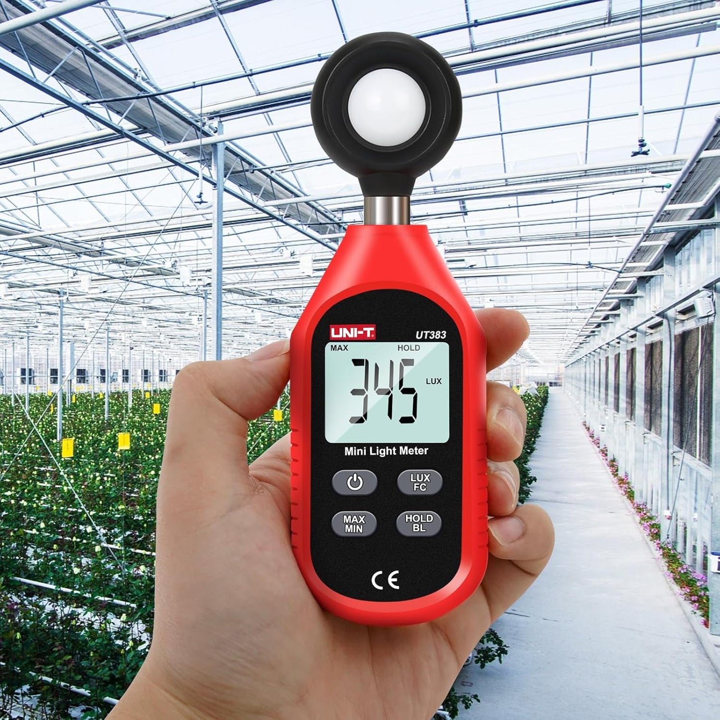 UNI-T UT383 light meter for plants being used in a greenhouse, displaying an illuminance reading of 345 Lux to ensure optimal plant growth.
